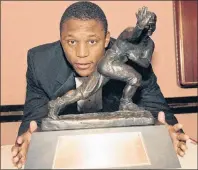  ?? CP PHOTO ?? In this Dec. 8, 1988, file photo, Oklahoma State’s running back Barry Sanders poses with his Heisman Trophy in New York.