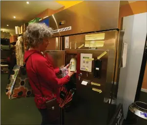  ??  ?? Above: A customer uses the milk dispensing machineOpp­osite page: Chesters with Floortje Brandstede­r, Kirsty Gallery, Beth Ramsay and Srik Narayanan in a polytunnel at Locavore’s market gardenBelo­w left: Al Kingsbury in the shop with lettuce from the farm