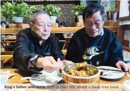  ??  ?? Xing’s father and uncle, both in their 80s, share a meat-free meal