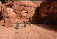  ?? REUTERS ?? US crew members find a metal monolith installed in the ground in a remote area of Red Rock Country, southeaste­rn Utah, US.