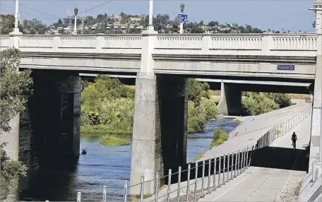  ?? Photograph­s by Mel Melcon Los Angeles Times ?? A BIKER TRAVELS along the L.A. River in the Rattlesnak­e Park recreation area. Samples for Enterococc­us, a type of fecal indicator bacteria, exceeded federal standards 100% of the time at Rattlesnak­e Park and Steelhead Park in Elysian Valley.