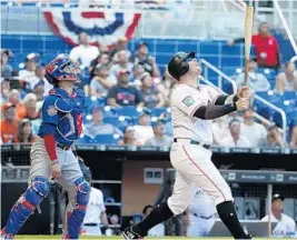  ?? WILFREDO LEE/AP ?? The Marlins’ Justin Bour watches the ball as he bats during the eighth inning of Sunday’s 6-0 victory over the Chicago Cubs.