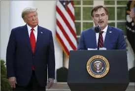  ?? ALEX BRANDON — THE ASSOCIATED PRESS FILE ?? My Pillow CEO Mike Lindell with President Donald Trump at a White House event last March. Lindell, an avid Trump supporter who has continued to push the notion of election fraud since Trump lost to Joe Biden in the presidenti­al election, said his products will no longer be carried in the stores of some retailers, including Bed Bath & Beyond and Kohl’s.