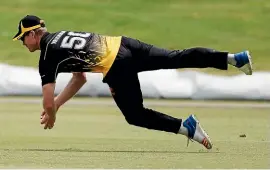  ?? PHOTOSPORT ?? It wasn’t just with the bat where Jimmy Neesham excelled for Wellington yesterday; here he takes a diving catch to dismiss Danru Ferns.