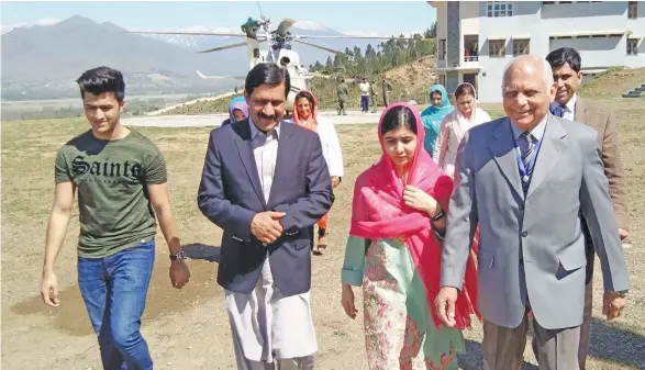 ??  ?? Nobel Peace Prize laureate Malala Yousafzai (third from left), now 20, arrives along with her brother Atal Yousafzai, (first from left), father Ziauddin Yousafzai (second from left), and local college principal Guli Bagh (right) in her hometown of...