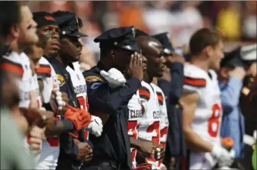  ?? RON SCHWANE — THE ASSOCIATED PRESS ?? Cleveland Browns players and Cleveland police stand together during the national anthem before an NFL football game between the Pittsburgh Steelers and the Cleveland Browns, Sunday, Sept. 10, in Cleveland.