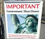  ?? AP/TED SHAFFREY ?? This sign was posted Saturday at the ferry to Ellis Island and the Statue of Liberty in New York after the government shutdown began at midnight.