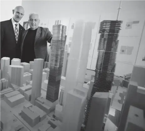  ?? COLIN MCCONNELL/TORONTO STAR ?? David Mirvish and Frank Gehry with a model of their King St. W. project at the Art Gallery of Ontario.