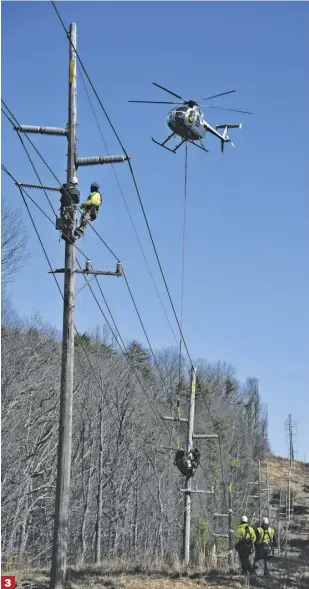  ??  ?? 3
3 | Two Ohio-based helicopter linemen from J W Didado Electric are airlifted to difficult-to-reach power lines near Pearl Lane in Sperryvill­e.