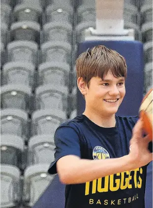  ?? PHOTO: GREGOR RICHARDSON ?? Fantastic . . . Otago Nuggets supporter Charlie Bauchop (14) passes a ball at the Edgar Centre this week as Nuggets centre Sam Timmins watches.