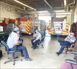  ?? Katie West • Times-Herald ?? The Forrest City Fire Department gather at Station 1 in the bay for further training. The department worked several grass fires yesterday.