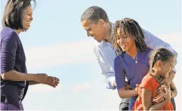  ?? LINDA DAVIDSON/THE WASHINGTON POST FILE ?? Michelle Obama and her daughters greet Barack Obama at a campaign stop in Colorado in 2008. In her memoir, she writes that she was a reluctant political spouse.