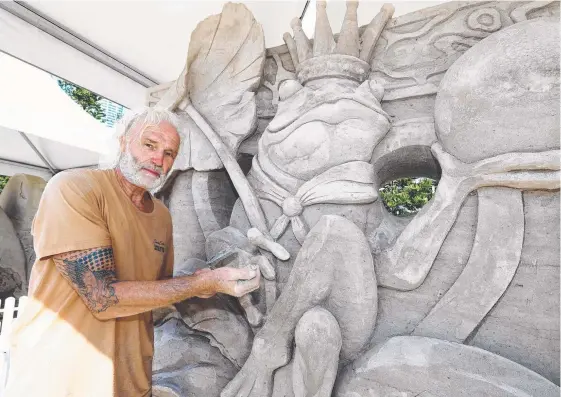  ??  ?? Artist Jino Van Bruinessen won the Australian Sand Sculpting Championsh­ips at Surfers Paradise yesterday and (below) Julian Briones.
Pictures: JASON O'BRIEN