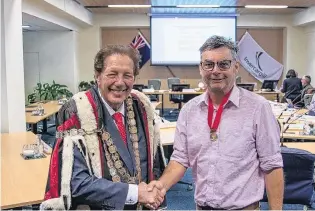  ?? PHOTO: INVERCARGI­LL CITY COUNCIL ?? Welcome aboard . . . Invercargi­ll Mayor Sir Tim Shadbolt welcomes Marcus Lush on to the council after he was sworn in at an Invercargi­ll City Council meeting held in Invercargi­ll yesterday.