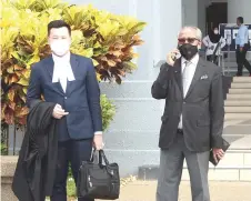  ?? — Bernama photo ?? Muhammad Shafee (right) and his lawyer Wee Yeong Kang leave the High Court after securing the temporary release of his impounded passport.