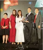  ??  ?? Kok (centre) presenting Tan with the Malaysian Rubber Export Promotion Council Industry Awards for Best Marketer in 2018.