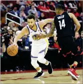  ?? AP PHOTO BY DAVID J. PHILLIP ?? Golden State Warriors' Stephen Curry, left, drives toward the basket as Houston Rockets' Gerald Green (14) defends during the first half of an NBA basketball game Thursday in Houston.