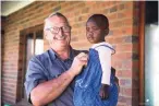  ?? ?? Jack Haskins with one of the children supported by the Angels’ Care Centre in Howick.