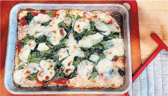  ?? ELIZABETH KARMEL
THE ASSOCIATED PRESS ?? Sheet-pan pizza is Elizabeth Karmel’s second favourite way to make the dish as you still get a crispy crust and it is virtually foolproof.