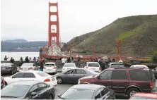  ?? Paul Chinn / The Chronicle ?? Motorists waiting for parking spaces create a logjam at the north vista point of the Golden Gate Bridge.