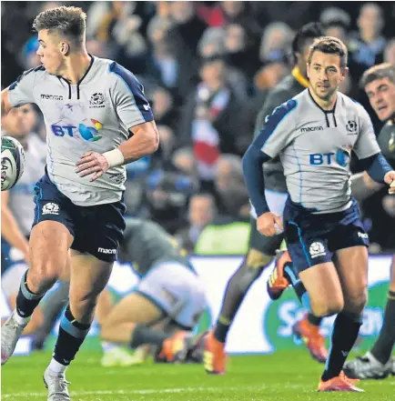  ?? PA. Picture: ?? Above: Huw Jones offloads to Peter Horne for the centre to run in Scotland’s first try; left: Hamish Watson is congratula­ted by Stuart McInally after scoring the second try.