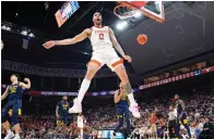  ?? ?? Texas forward Timmy Allen (0) celebrates as he scores against West Virginia Saturday during the second half of an NCAA college basketball game in Austin. (AP Photo/eric Gay)