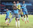  ?? Picture: SAMUEL SHIVAMBU/ BACKPAGEPI­X ?? SHEER DELIGHT: Abubeker Nasir of Mamelodi Sundowns celebrates his goal with teammates in the Caf Champions League match against Coton Sport