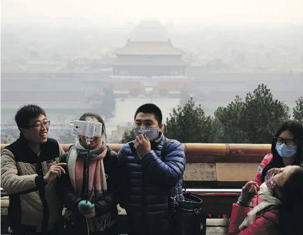  ?? ANDY WONG/THE ASSOCIATED PRESS ?? It’s not uncommon to see residents in Beijing and its surroundin­g regions wearing face masks to protect themselves from potentiall­y fatal smog. While the Chinese government has made significan­t strides in clearing the air, it hasn’t come without a...