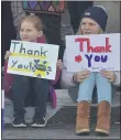  ?? PETE BANNAN - MEDIANEWS GROUP ?? Molly Foreman, 9, and Tabitha Shatney, 13, both of Chester, show their thanks to veterans during the 2019 Delaware County Veteran’s Day Parade in Media.