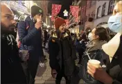  ?? JEAN-FRANCOIS BADIAS — THE ASSOCIATED PRESS FILE ?? On Dec. 17, people enjoy a glass of mulled wine in the street before the curfew in Strasbourg, eastern France.