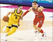  ?? Jay LaPrete Associated Press ?? IOWA’S C.J. Fredrick, left, dribbles past Ohio State’s Justin Ahrens en route to the Hawkeyes’ upset win.