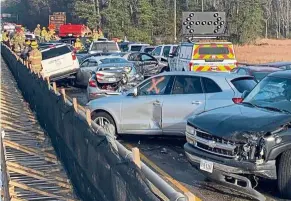  ?? — AFP ?? crash, boom, bang: Damaged vehicles after the accident on the I-64 highway in York county near Williamsbu­rg, Virginia.