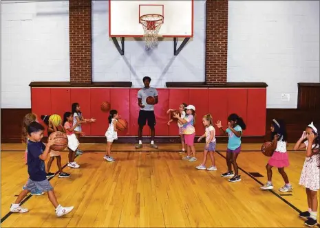  ?? Ned Gerard / Hearst Connecticu­t Media ?? UConn forward Richie Springs works with summer campers during a visit to the Wakeman Boys & Girls Club on Monday in Fairfield.