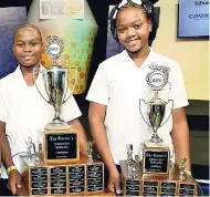  ?? FILE ?? Nathaniel Stone (left), the 2018 Gleaner’s Children’s Own Spelling Bee champion, and Assana Thompson, third-place winner, shortly after they received their trophies at the TVJ studios earlier this year.