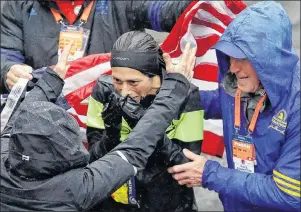  ?? AP PHOTO ?? Desiree Linden, center, of Washington, Mich., celebrates after winning the women’s division of the 122nd Boston Marathon on Monday, in Boston.