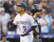  ?? David Zalubowski / Associated Press ?? Colorado’s Carlos Gonzalez had two home runs and six RBIs in the Rockies’ 19-2 win over Arizona.