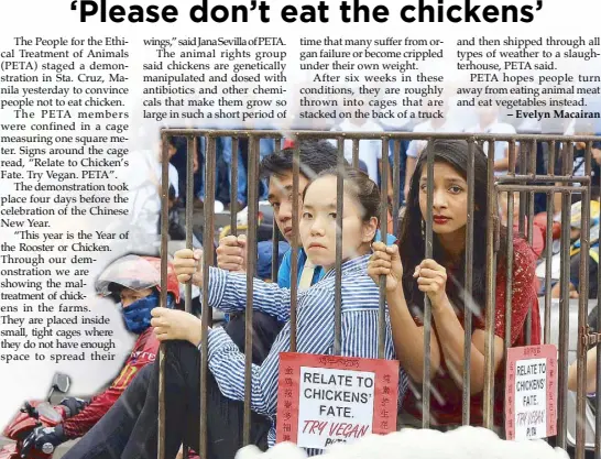  ?? EDD GUMBAN ?? Members of the activist group People for the Ethical Treatment of Animals hold a silent protest in a cage to symbolize the plight of chickens during the runup to the Chinese New Year in Binondo, Manila yesterday.