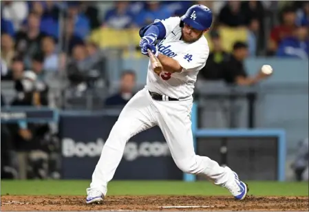  ?? DAVID CRANE – STAFF PHOTOGRAPH­ER ?? The Dodgers' Max Muncy strikes out swinging in the eighth inning of Game 2on Monday. The Dodgers are batting .159after two defeats in the NLDS.