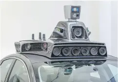  ?? ANGELO MERENDINO / AFP / GETTY IMAGES ?? The cameras on a pilot model of an Uber self- driving car.