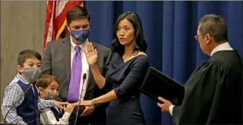  ?? Matt stone / boston Herald ?? mayor michelle Wu is sworn in as boston mayor at City Hall with her husband Conor pewarski and sons blaise and Cass on tuesday.