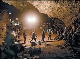  ?? LILLIAN SUWANRUMPH­A/GETTY-AFP ?? Thai soldiers gather Tuesday during a rescue operation for members of a boys soccer team and their coach, who have been missing since a Saturday visit to a cave complex.