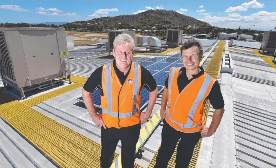  ?? ENVIRONMEN­T NO. 1: Tip Top NQ operations manager Shaun Schostakow­ski and maintenanc­e manager Martin Komberec with their 306- panel solar array. ??