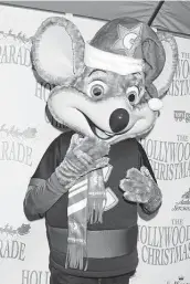  ?? Kathy Hutchins / TNS file photo ?? Chuck E. Cheese appears at the 2016 annual Hollywood Christmas Parade in Los Angeles. Embracing technology and adapting to trends have kept the chain going, says CEO David Mckillips.