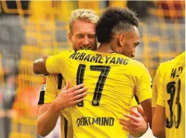  ??  ?? Dortmund’s Andre Schuerrle, left, embraces teammate Pierre-Emerick Aubameyang, after the latter scored against Mainz Photo: AP