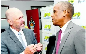  ?? Rudolph Brown/Photograph­er ?? Former JPS President and CEO Steve Berberich (left) speaking with Dr Tomlin Paul, UWI deputy principal, Mona, at the MOU Signing between JPS Foundation and The UWI CAPE Workshops at JPS head office on Knutsford Boulevard in New Kingston on Thursday, August 31, 2023. Berberich, who recently resigned from the JPS, has joined United States firm Onward Energy.