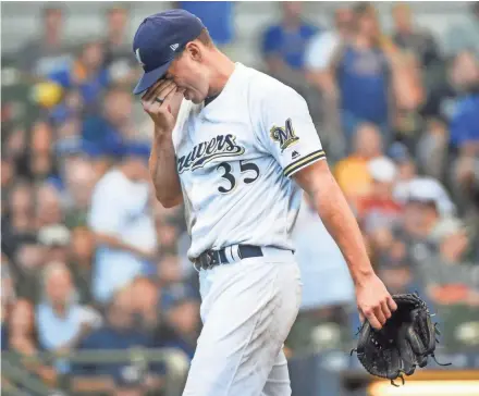  ?? BENNY SIEU / USA TODAY SPORTS ?? Brent Suter walks off the mound after the third inning Sunday.