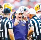  ?? THE ASSOCIATED PRESS ?? Former LSU football coach Les Miles, center, will be back at Death Valley on Saturday to be honored as part of Saturday’s game against Auburn.