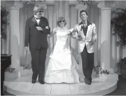  ?? A Elvis Chapel via AP ?? In this image made from a video provided by A Elvis Chapel, David Allen Turpin, left, and his wife, Louise Anna Turpin, center, celebrate a renewal of their wedding vows with Elvis impersonat­or Kent Ripley on Oct. 29, 2011, in Las Vegas. The couple was...