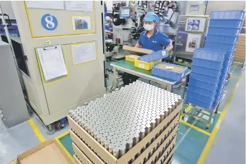  ??  ?? Batteries for electric vehicles are manufactur­ed at a factory in Dongguan, China. The growth of China’s electric vehicle industry – and the ambitions of recycling companies – is underpinne­d by a government drive to eventually phase out gasoline-burning...