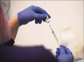  ?? Tyler Sizemore / Hearst Connecticu­t Media ?? Registered nurse Carly Plymel preps a dose of the Pfizer COVID-19 vaccine at the Stamford Health Vaccinatio­n Super Site on April 6.